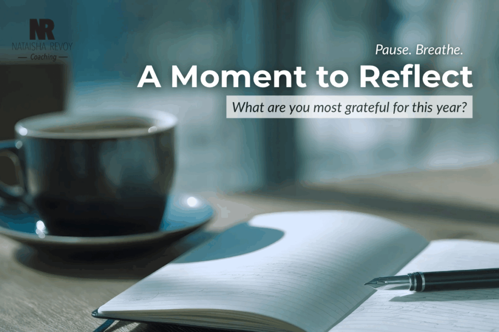 Open notebook and pen beside a warm cup of tea, symbolizing self-reflection and gratitude